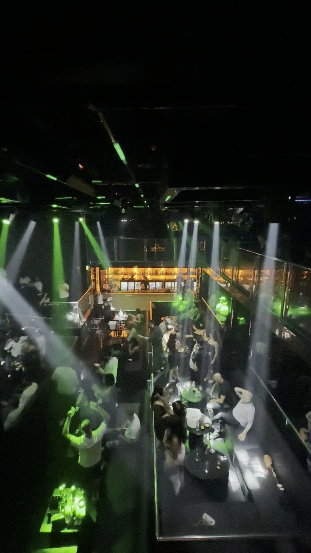 Elevated balcony perspective overlooking the illuminated cocktail bar and mezzanine tables at XOXO Nightclub & Lounge Dubai
