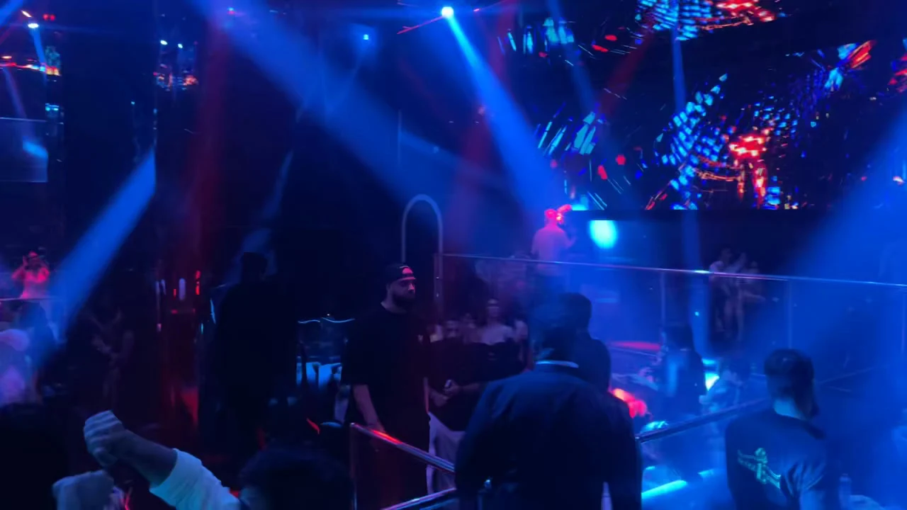 Blue spotlights and dynamic LED stage visual graphics across the performance stage at XOXO Nightclub & Lounge Dubai