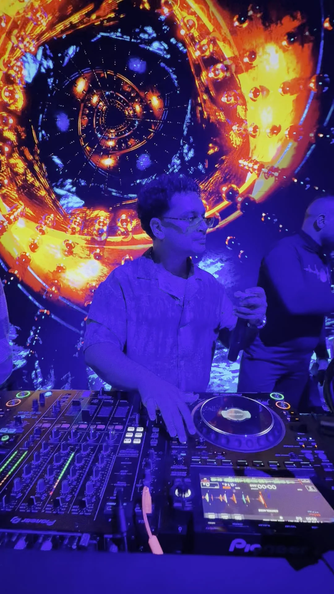 Resident DJ mixing electronic tracks on Pioneer multi-player decks before vibrant LED stage backdrop at XOXO Nightclub & Lounge Dubai
