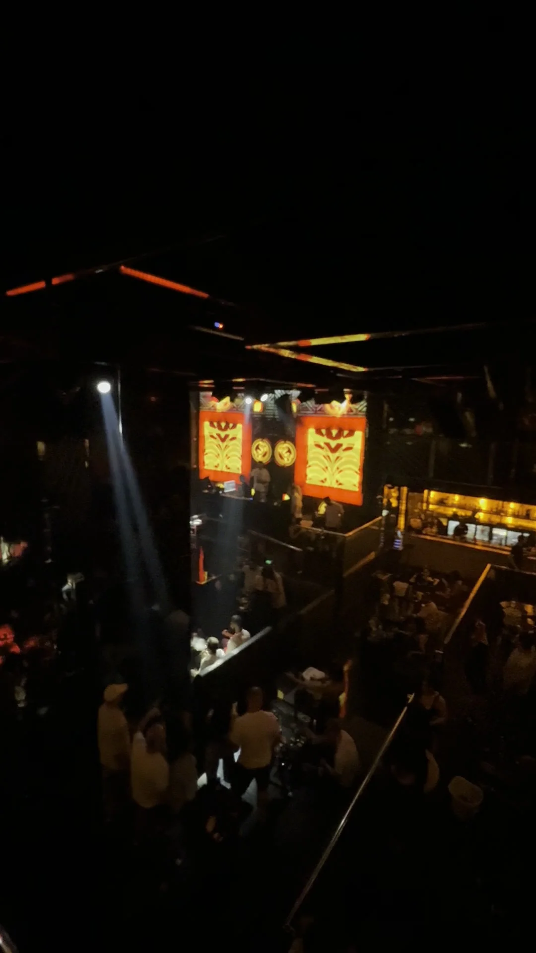 Elevated overview of the main room showing the stage, dancefloor and illuminated cocktail bar at XOXO Nightclub & Lounge Dubai