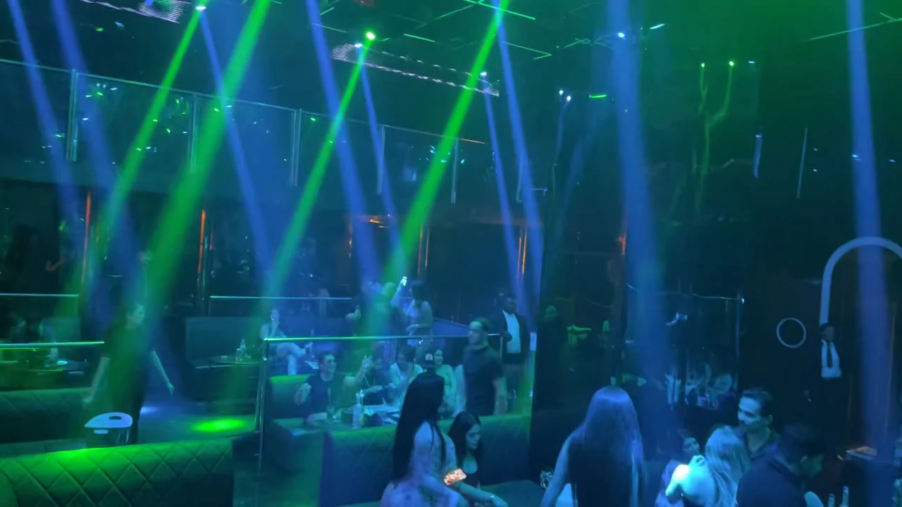 Laser beams reflecting across mirrored ceiling installations above the dancefloor at XOXO Nightclub & Lounge Dubai