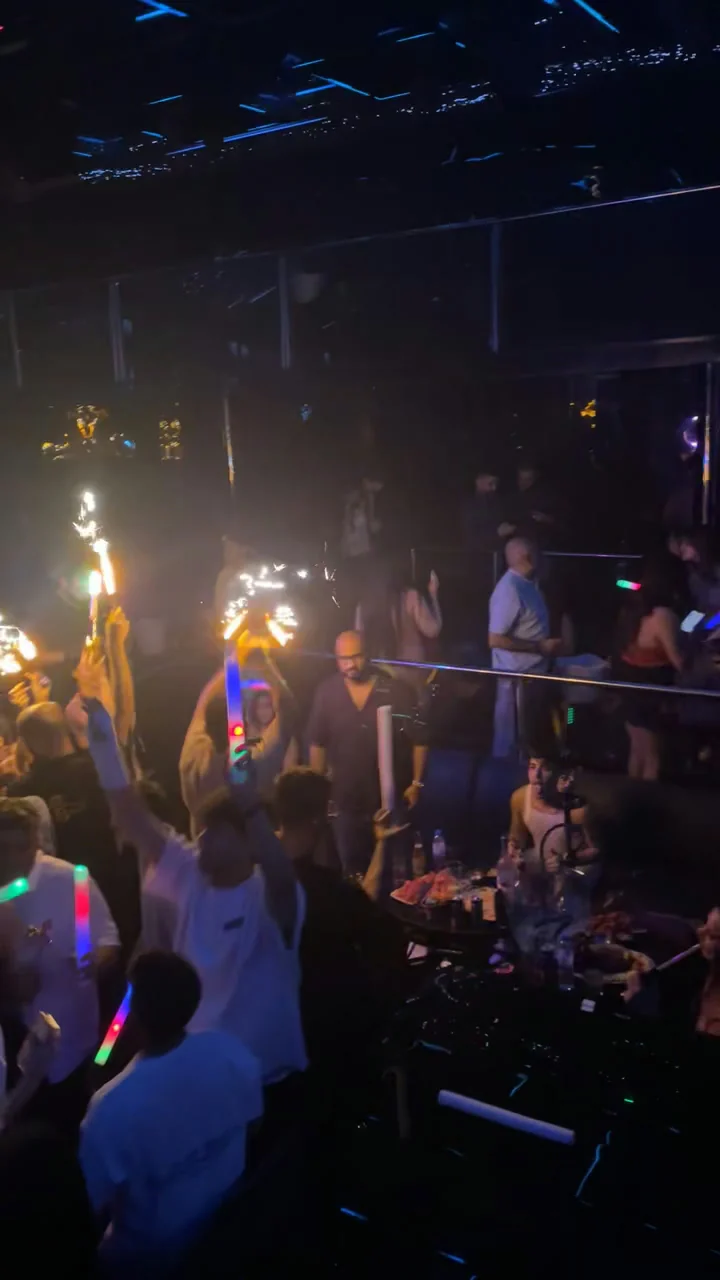 VIP bottle celebration with sparklers, illuminated LED batons and celebrating guests at XOXO Nightclub & Lounge Dubai